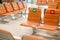 Row of empty bench chair seats in public transportation terminal with social distancing guidance during Coronavirus