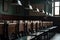 a row of empty chairs in a lecture hall with an old-fashioned blackboard and ceiling lights