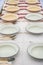 Row of empty enamel plates on the table set for dinner