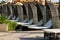 Row of empty sun loungers with soft white mattresses and rattan canopy