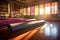 row of empty yoga mats in a sunlit studio