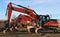 Row of excavators lined up in a construction site