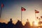 A row of flying flags of nations on sunset sky background. Flags of different countries