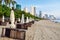 Row of folded beach umbrellas and sun loungers on a sandy beach by the sea