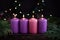 A row of four burning purple advent candles Christmas concept