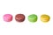 Row of four macaroons with different colors and varied taste, lemon, almond, chocolate, raspberry, strawberry and mint isolated