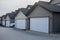 Row of garage doors at parking area for townhouses. Private garages for storage or cars in rows in an alley