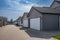 Row of garage doors at parking area for townhouses. Private garages for storage or cars in rows in an alley