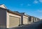 Row of garage doors at parking area for townhouses. Private garages for storage or cars in rows in Canada