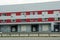 A row of garages in a gray red large building