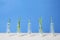 Row of glass bottles with rosemary and thyme