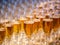 a row of glasses filled with champagne are lined up ready to be served