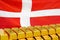 Row of gold bars on the Denmark flag background. Concept of gold reserve and gold fund of Denmark