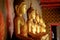 Row of golden buddha statue at Wat Arun, Bangkok Thailand. Landmark of Thailand and asia