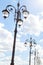 Row of graceful triple street lamp posts under sunlight against