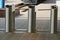 Row of gray iron turnstiles on the sidewalk