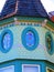 Row of green Victorian oval windows with stained glass