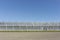 A row of greenhouses under a deep blue sky