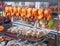 Row of grilled fish and hens on the street market