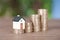 A row of growing euro coins and a miniature house mode