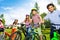 Row of happy children in bike colorful helmets