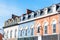 Row of historic buildings with dormer windows on a clear autumn day