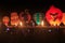 A row of hot air balloons lit up at night