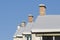 Row of house chimneys and rooftops wintertime