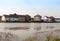 Row of houses coast marina dock other side of river