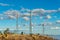 Row of industrial radio towers on summit of mountain in arizona with cloudy desert skies and blue with dry grass