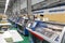 A row of industrial textil flat knitting machines in a knitwear factory