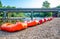 Row of inflatable rafts at the beginning of a float trip on a river.