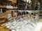 Row of inverted glass goblets for wine tasting at the alcohol department of Eataly Roma