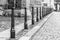 Row of iron pillars between cobbled street and pedestrian sidewalks