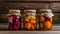 A row of jars filled with a variety of vegetables including pickles, peppers, and carrots