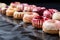 a row of jelly-filled donuts on baking paper