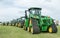 A row of John Deere Tractors at show