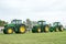 A row of John Deere Tractors at show