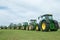 A row of John Deere Tractors at show