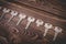 A row of keys on a wooden background. One of the keys is not like the others, it is broken