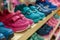 row of kids shoes displayed on a shelf