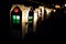 A row of lanterns made from milk cartons in the dark.