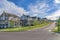 Row of large two-storey houses near the paved uphill road at Daybreak, Utah