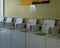 Row of laundry coin operated laundry machines inside a laundromat