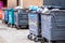 Row Or Line Of Full Commercial Wheelie Bins Waiting Collection