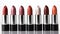 Row of lipstick in varying shades on white background