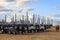 Row of logging trucks with stacked trailers