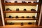 Row of man`s different shoes on four wooden shelves