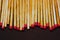 A row of matches with heads of red sulfur