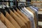 A row of men\\\'s suits, jackets hanging on a rack for display